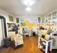 A kitchen in a family house with a wooden decor floor and lots of decorations.