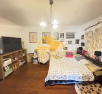 Bedroom with wooden decor, bed, and decorations in a family house.