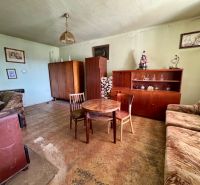 Living room in a family house with furniture and flooring featuring a wood decor.