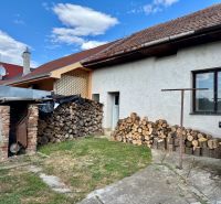 A family house in Horné Obdokovce with wood stored in the yard and a shelter.