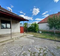 A family house in Horné Obdokovce with a concrete courtyard and a garden behind the fence.
