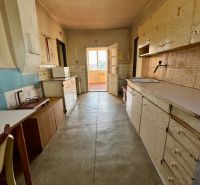 A kitchen room in a family house with a wooden decor on the floor.