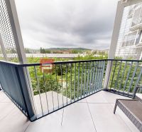 A balcony in a 2-room apartment with a view of greenery and mountains in Bratislava III.