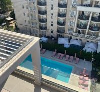 A view of the pool at the apartment house in Sveti Vlas with loungers and gazebos.