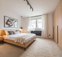 A bright bedroom in a 4-room apartment with a large bed and a built-in wardrobe.