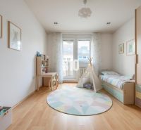 Children's room in a 4-room apartment with wood-decor flooring, canopy, and furniture.