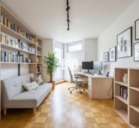 A study in a 4-room apartment with a wooden decor floor and bookshelves.