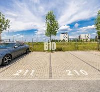 Parking lot with an available space and buildings in the background on Jána Langoša Street in Bratislava IV.