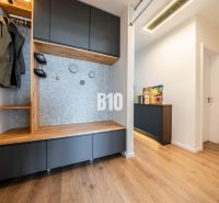 Hallway in a 3-room apartment with furniture and flooring featuring a wood decor.