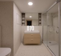 A bathroom with a bathtub, sink, and toilet in a 2-room apartment, neutral decor.