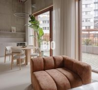 A bright living room with a comfortable sofa in a two-room apartment, with a dining table.