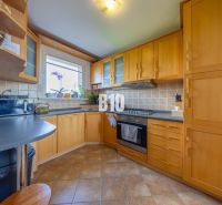 A kitchen in a 3-room apartment with a wooden decor and practical arrangement of appliances.