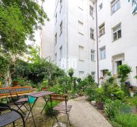 A flower garden with seating by a 2-room apartment on Kozia Street in the Old Town of Bratislava.