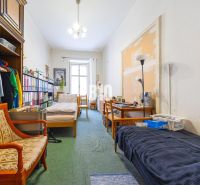 A room in a 2-room apartment with antique furniture and large storage space.