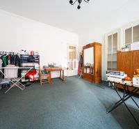 Living room in a two-room apartment with wooden furniture and a carpet.