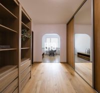 A hallway with built-in wardrobes and a floor with a wooden decor in a 3-room apartment.