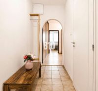 A narrow hallway with a flower vase in a 3-room apartment.