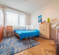 Bedroom in a 3-room apartment with a bed, furniture, and flooring with a wooden decor.