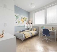 Children's room in a 3-room apartment with a wooden decor floor and a study desk.