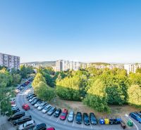 View of apartment buildings and greenery in Nitra, with a 3-room apartment in the background.