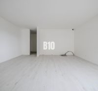 A bright room with a wooden decor floor in a studio apartment.