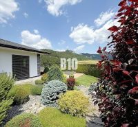 The exterior of a family house in Súľov-Hradná, a landscaped garden with a view of the mountains.