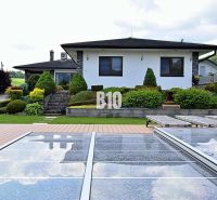 A family house in Súľov-Hradná with a swimming pool and a landscaped garden in a peaceful countryside.