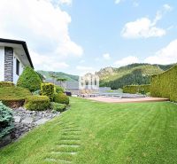 The garden of a family house in Súľov-Hradná with a swimming pool and well-maintained lawn.