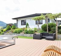 A family house in Súľov-Hradná with a terrace, swimming pool, and garden seating against the backdrop of mountains.