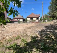 A residential plot in Rákoš ready for construction, surrounded by family houses.