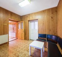 Wooden wall cladding and geometric flooring in the interior of a family house.