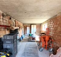 Interior of a family house with brick walls and building materials.