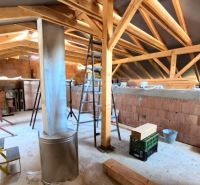 The attic of a family house under construction with wooden beams and building materials.