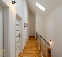 A hallway in a 4-room apartment with a wooden decor floor and a skylight.