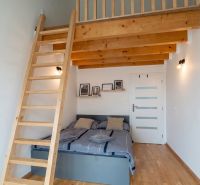 Bedroom in a 4-room apartment with a gallery and a wooden decor floor.