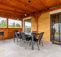 Terrace of a 4-room apartment with wooden decor and outdoor seating.