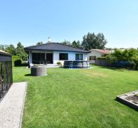 A family house in Šajdíkové Humence with a terrace, swimming pool, and well-maintained garden.