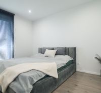 Bright bedroom with a bed and decoration in a family house, floor with wood decor.