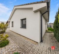 A family house in Bratislava-Podunajské Biskupice with a paved walkway and a landscaped garden.