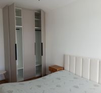 Bedroom in a 2-room apartment with a bed, wardrobe, and nightstand.