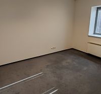 Room with carpet, white walls, and a window with blinds in an office.