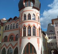 A historic building with rounded towers at the Courtyard of Europe in Komárno, commercial spaces.
