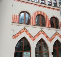 A building with colorful bricks and arched windows at the Courtyard of Europe in Komárno.