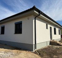 A family house in Oponice with a white facade and two windows.