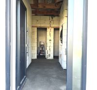 Construction of a family house in Čaňa with entrance doors and unfinished walls.