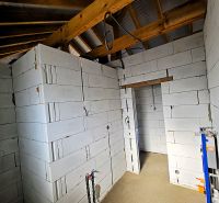 Construction of a family house with wooden beams and brick walls in Čaňa.