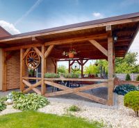 A terrace with a wooden pergola and a garden in Lehoty by a family house.