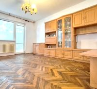 Living room with wood-patterned flooring and furniture in a family house.