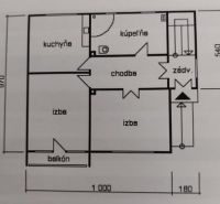 Floor plan of a family house with a kitchen, bathroom, two rooms, and a balcony.
