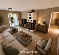 Living room in a family house with a fireplace and wood-patterned flooring, light-colored seating.
